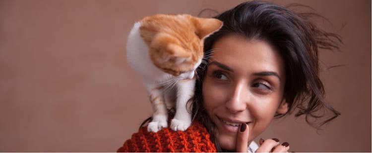 Woman with cat on her shoulder.