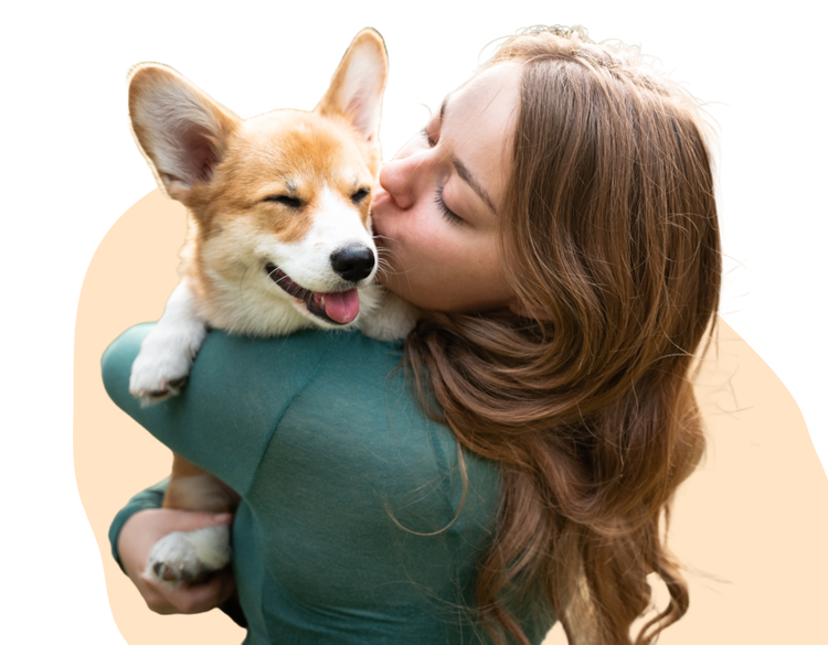 A woman hugging and kissing her dog.